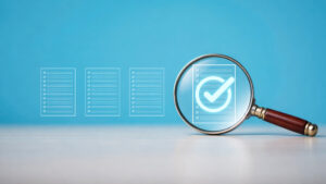 Quality assurance concept: magnifying glass inspecting a checklist on a blue background, emphasizing verification of items.
