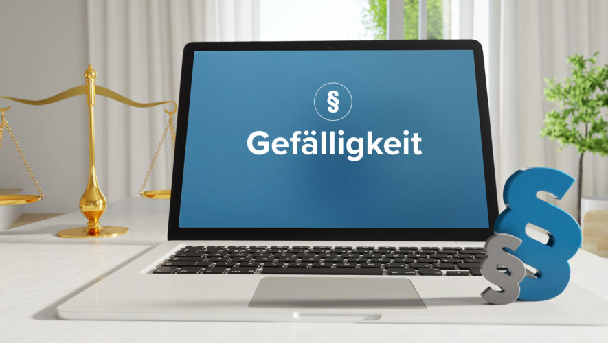 Laptop screen shows the German word 'Gefälligkeit' on a blue background, with a gold balance scale to the left and a large blue ampersand on the right.