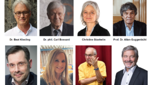 Portrait of Dr. Beat Kissling, looking at the camera against a textured background, wearing glasses and a white shirt.