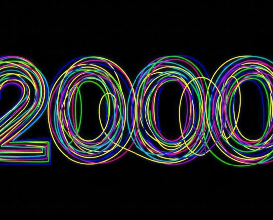 Neon rainbow loops form the number 2020 on a black background, festive and vibrant.