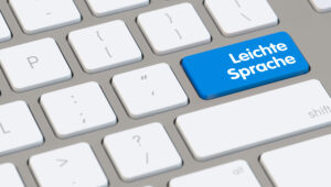 Blue key on a keyboard labeled 'Leichte Sprache' (Easy German) among white keys