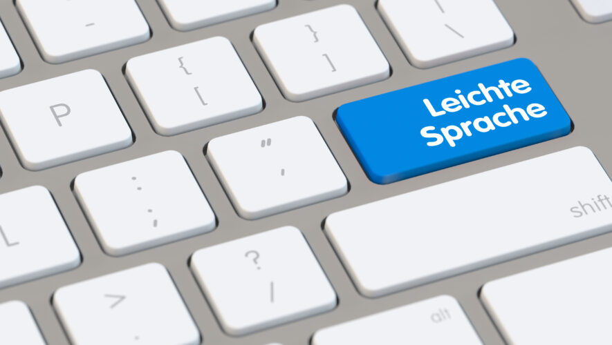 Blue key on a keyboard labeled 'Leichte Sprache' (Easy German) among white keys