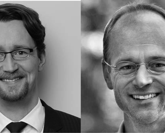 Two men in a split image, both smiling; left man in a suit and glasses, right man with round glasses and a light jacket.